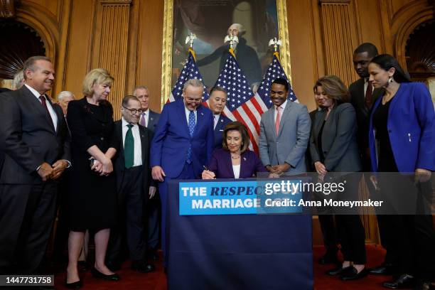 House Speaker Nancy Pelosi participates in a bill enrollment ceremony alongside Senate Majority Leader Chuck Schumer and a bipartisan group of...