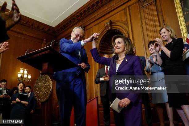 House Speaker Nancy Pelosi high fives Senate Majority Leader Chuck Schumer as Sen. Susan Collins and Sen. Tammy Baldwin look on during a bill...