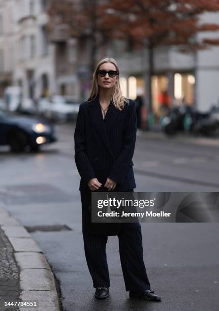 Model und Content Creator Marlies Pia Pfeifhofer wearing LeGer by Lena Gercke navy blue pinstriped suit, Ray-Ban black sunglasses, Laura Lombardi...