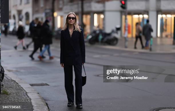 Model und Content Creator Marlies Pia Pfeifhofer wearing LeGer by Lena Gercke navy blue pinstriped suit, Ray-Ban black sunglasses, Laura Lombardi...