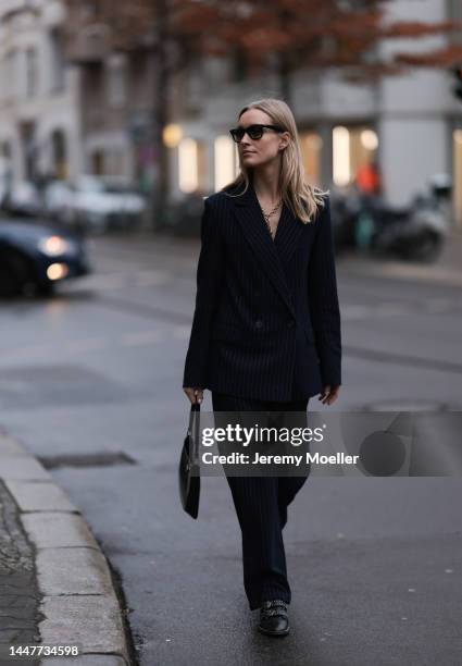 Model und Content Creator Marlies Pia Pfeifhofer wearing LeGer by Lena Gercke navy blue pinstriped suit, Ray-Ban black sunglasses, Laura Lombardi...