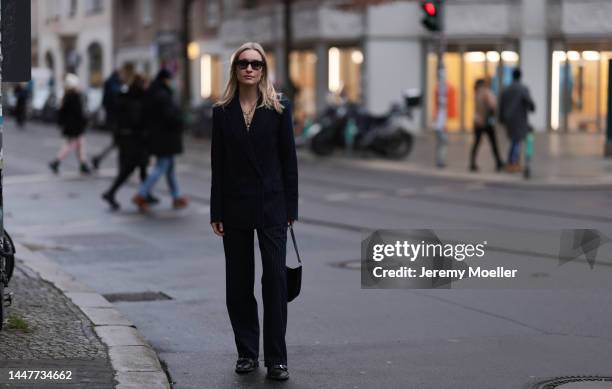 Model and Content Creator Marlies Pia Pfeifhofer wearing LeGer by Lena Gercke navy blue pinstriped suit, Ray-Ban black sunglasses, Laura Lombardi...