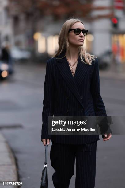 Model and Content Creator Marlies Pia Pfeifhofer wearing LeGer by Lena Gercke navy blue pinstriped suit, Ray-Ban black sunglasses, Laura Lombardi...