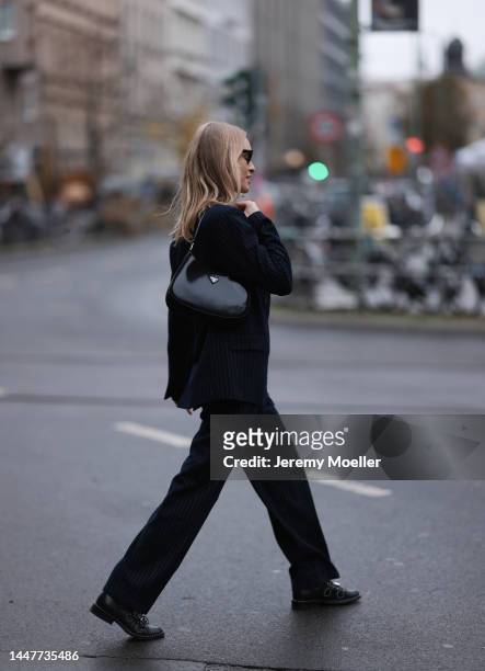 Model and Content Creator Marlies Pia Pfeifhofer wearing LeGer by Lena Gercke navy blue pinstriped suit, Ray-Ban black sunglasses, Givenchy black...