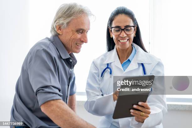 medical doctor attending a patient - 50 year old male patient stock pictures, royalty-free photos & images