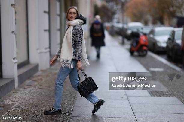 Model und Content Creator Marlies Pia Pfeifhofer wearing Dior black/white checked blazer jacket, Dior black hooded gilet, Agolde Criss Cross blue...