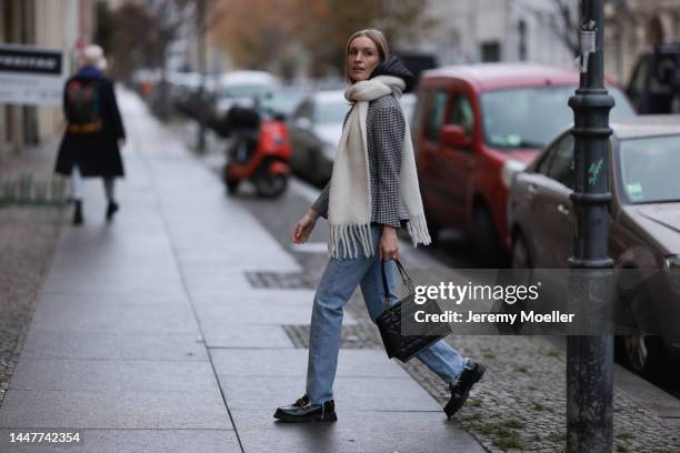 Model und Content Creator Marlies Pia Pfeifhofer wearing Dior black/white checked blazer jacket, Dior black hooded gilet, Agolde Criss Cross blue...