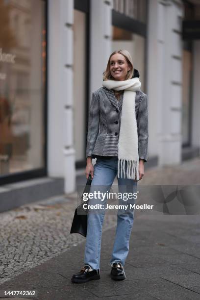 Model and Content Creator Marlies Pia Pfeifhofer wearing Dior black/white checked blazer jacket, Dior black hooded gilet, Agolde Criss Cross blue...