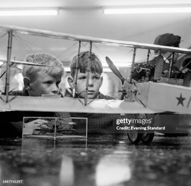 Two boys named as Paul Roxan and Nicholas Roxan looking at the model of a plane at the Model Engineer exhibition at Central Hall, Westminster, on...