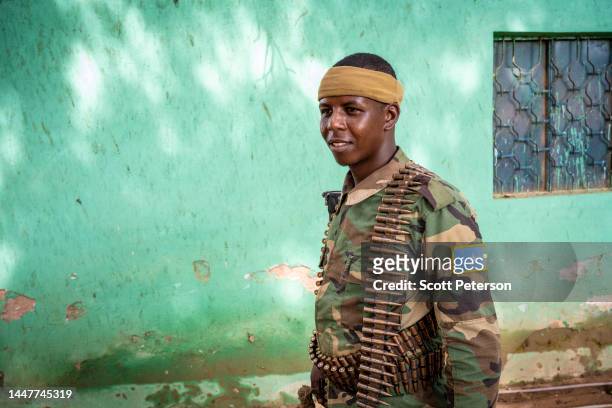 Draped in bandoliers of bullets, armed Somali security guards man the compound of the city mayor in Baidoa, Somalia, on November 9, 2022. The...