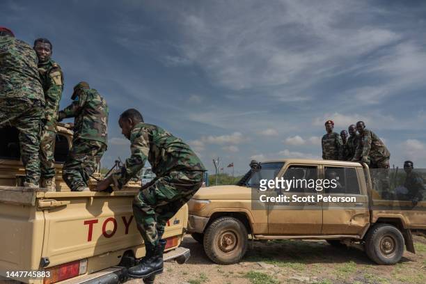 Soldiers of the Somali National Army and Somalia security forces load onto vehicles at the airport in Baidoa, Somalia, on November 9, 2022. The...