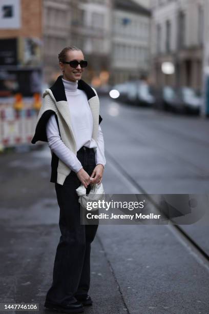 Model und Content Creator Marlies Pia Pfeifhofer wearing Allude white turtleneck sweater, Axel Arigato black/white knit pullover, Zara black denim...