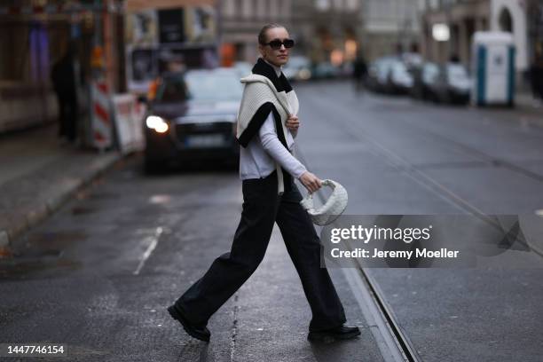 Model und Content Creator Marlies Pia Pfeifhofer wearing Allude white turtleneck sweater, Axel Arigato black/white knit pullover, Zara black denim...