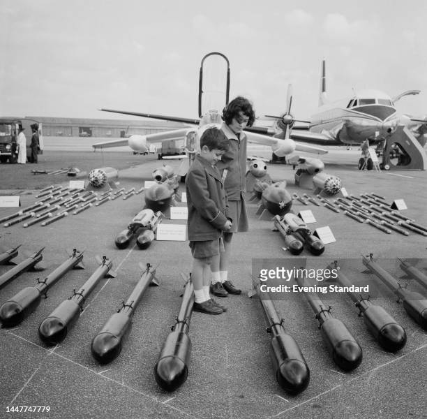 Two children viewing a display of aircraft ordnance at Farnborough Airshow in Hampshire in September 1961.