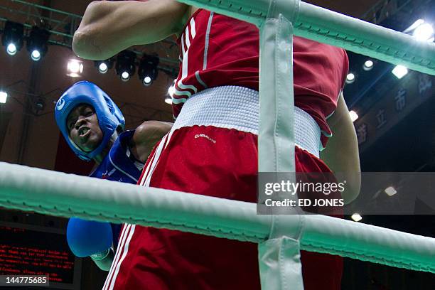 Ren Cancan of China clashes with Nicola Adams of England during their flyweight final bout at the Women's World Boxing Championships in Qinhuangdao...