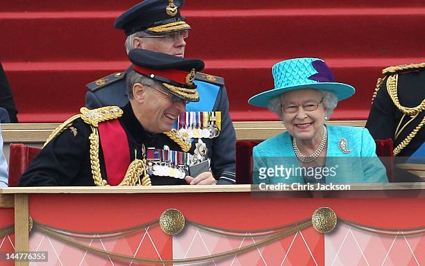 Queen Elizabeth II shares a joke with Chief of the Defence Staff General Sir David Richards at Home Park on May 19, 2012 in Windsor, England. Over...