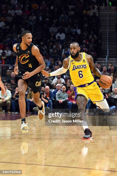 Evan Mobley of the Cleveland Cavaliers guards LeBron James of the Los Angeles Lakers during the third quarter at Rocket Mortgage Fieldhouse on...