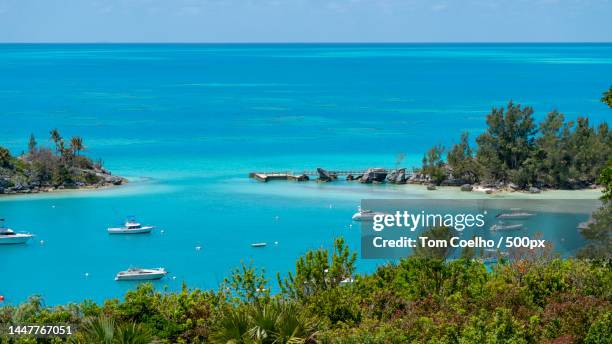 high angle view of boats in sea against sky,sandys parish,bermuda - bermuda stock pictures, royalty-free photos & images