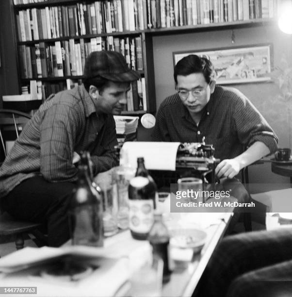 American writers Jack Kerouac and Albert Saijo read a page in a typewriter in the apartment of photographer Fred McDarrah and his soon-to-be wife,...