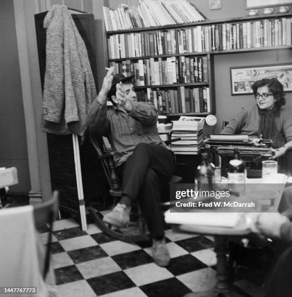 American writer Jack Kerouac and Gloria Schoffel sit together, the latter behind a typewriter in the apartment of her and her soon-to-be husband,...