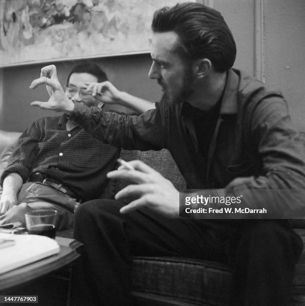 American writer Lew Welch gestures as he sits on a couch in the apartment of photographer Fred McDarrah and his soon-to-be wife, Gloria, New York,...