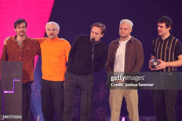 Kraftklub, winner of the 1Live Krone award for Best Alternative Song, speak on stage with their award at the 1 Live Krone 2022 at Jahrhunderthalle on...