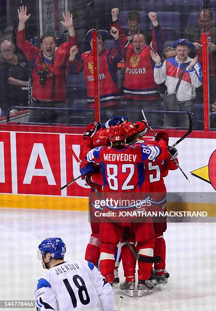 Russia's Denis Kokarev celebrates with his teammates after he scores a goal during a semi-final match against Finland at the Ice Hockey World...