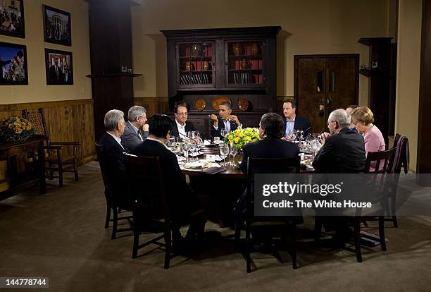 In this handout provided by The White House, U.S. President Barack Obama hosts a working dinner in Laurel Cabin, seated clockwise from the President...