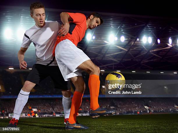 soccer skills - two guys playing soccer stockfoto's en -beelden