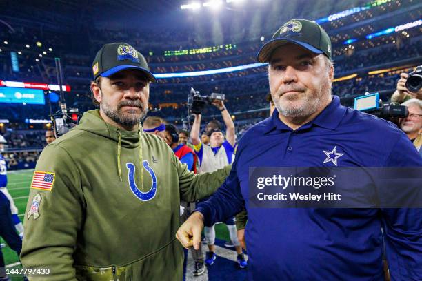 Head Coach Mike McCarthy of the Dallas Cowboys shakes hands after the game with Head Coach Jeff Saturday of the Indianapolis Colts at AT&T Stadium on...