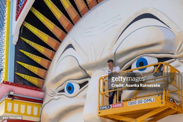 Melbourne artist Mark Ogge in front of the restored Mr Moon during a media call at Luna Park on December 09, 2022 in Melbourne, Australia. Luna Park...