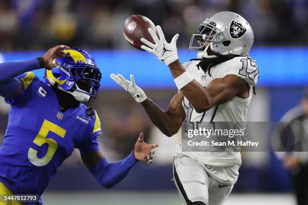 Davante Adams of the Las Vegas Raiders makes a reception past Jalen Ramsey of the Los Angeles Rams during the second quarter at SoFi Stadium on...