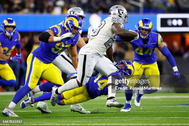 Josh Jacobs of the Las Vegas Raiders carries the ball against Cobie Durant of the Los Angeles Rams during the second quarter at SoFi Stadium on...