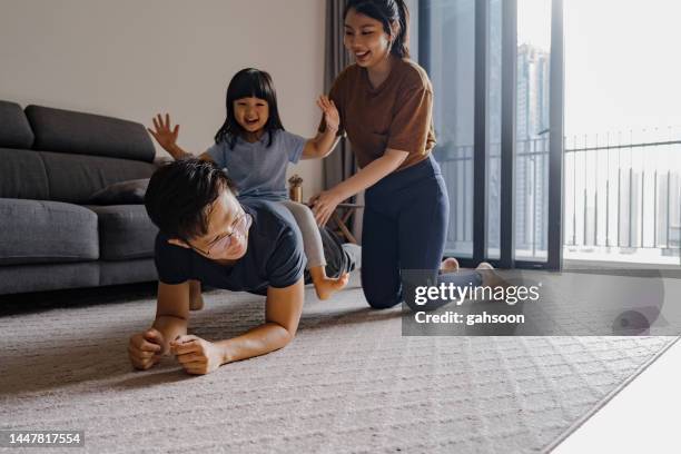 family morning exercise at home - malay exercise indoor stock pictures, royalty-free photos & images