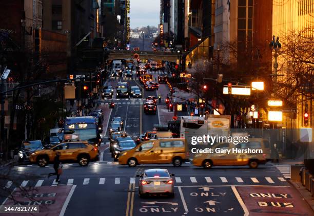 Taxi cabs cross 42nd Steet as the sun rises on December 8 in New York City.