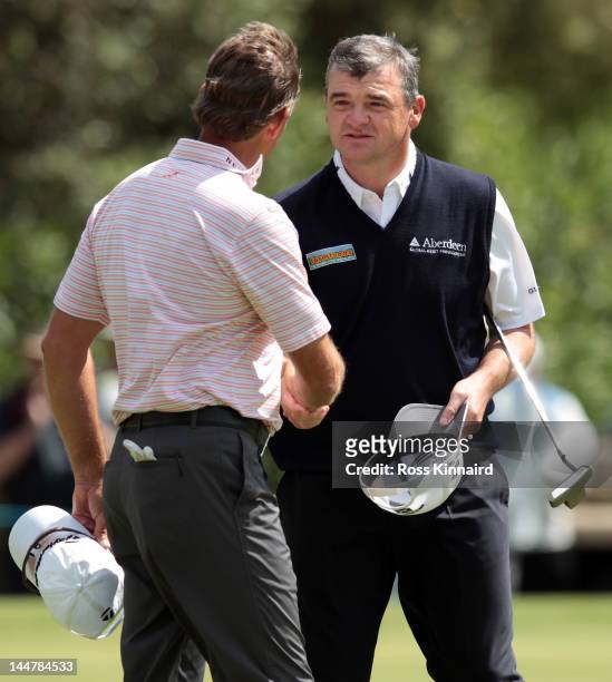 Paul Lawrie of Scotland is congratulated by Retief Goosen of South Africa after the quarter final matches on day three of the Volvo World Match Play...