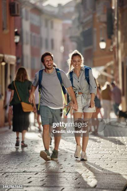 happy couple of tourists enjoying while walking on the city street. - croatia tourist stock pictures, royalty-free photos & images