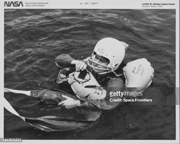 American NASA astronaut and biochemist Shannon Lucid wearing a protective headwear while being kept afloat with an inflatable life buoy during water...