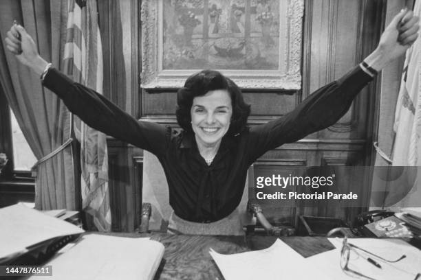American politician Dianne Feinstein, her arms outstretched in celebration, in her office after she was elected mayor of San Francisco, at San...