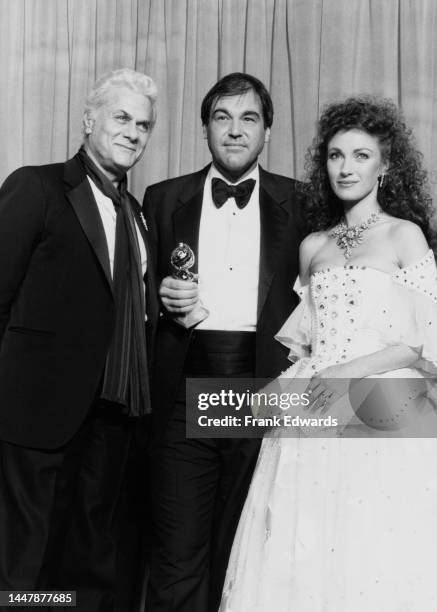 American actor Tony Curtis , American film director and screenwriter Oliver Stone, and British actress Jane Seymour in the press room of the 44th...