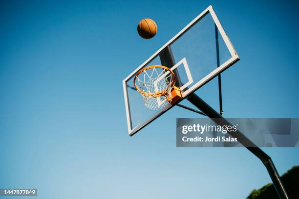 basketball ball getting in to the basket - basketball hoop bildbanksfoton och bilder