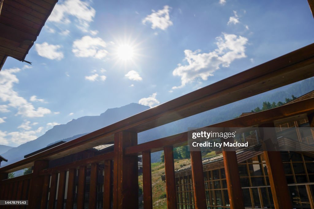 Sunny sky over the balcony of a chalet in the mountains