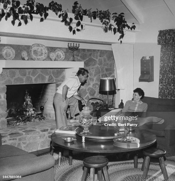 American actor Alan Ladd and his wife, American actress and talent agent Sue Carol in the living room of their home in Palm Springs, California,...