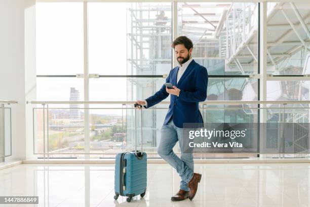 full length view of businessman with phone traveling with suitcase in white background window. - guy with phone full image ストックフォトと画像