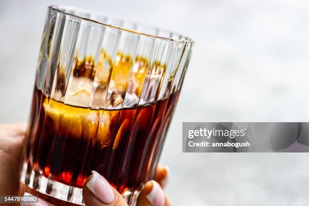 close-up of a woman's hand holding a drink - pepsi stock pictures, royalty-free photos & images