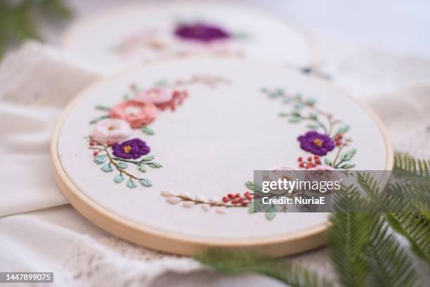 close-up of two embroidery hoops with floral decoration - embroidery frame stock pictures, royalty-free photos & images