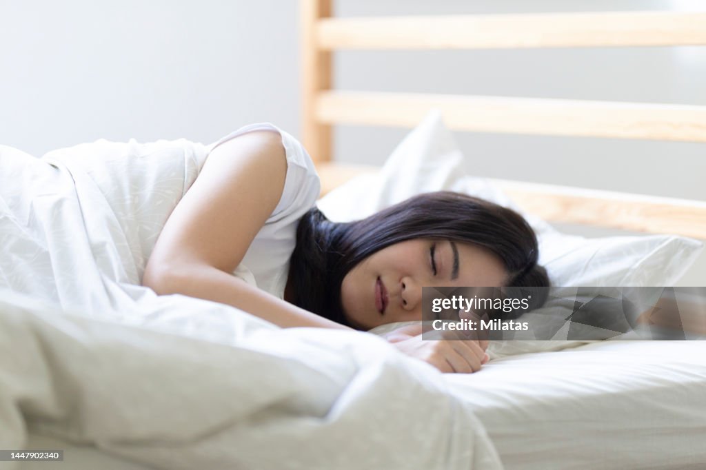 Woman sleeping on the bed in the bedroom