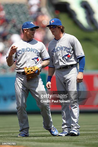Brett Lawrie of the Toronto Blue Jays jokes while talking to Colby Rasmus of the Blue Jays during the game against the Los Angeles Angels of Anaheim...