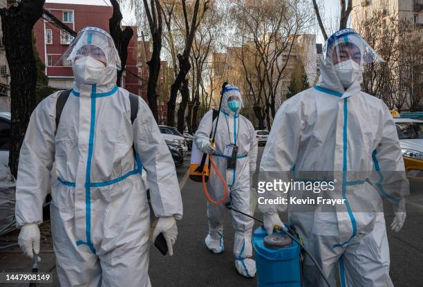 Epidemic control workers wear PPE as they walk to disinfect an epidemic area in a neighbourhood that recently was in lockdown due to COVID-19 cases...