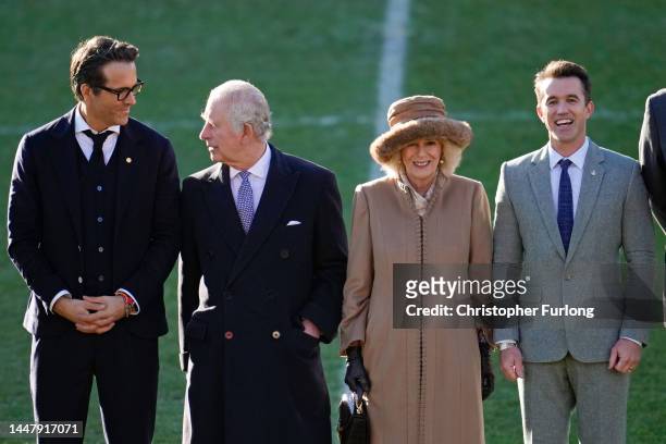 King Charles III and Camilla, Queen Consort talk to Co-Owners Wrexham AFC Ryan Reynolds and Rob McElhenney during their visit to Wrexham AFC on...